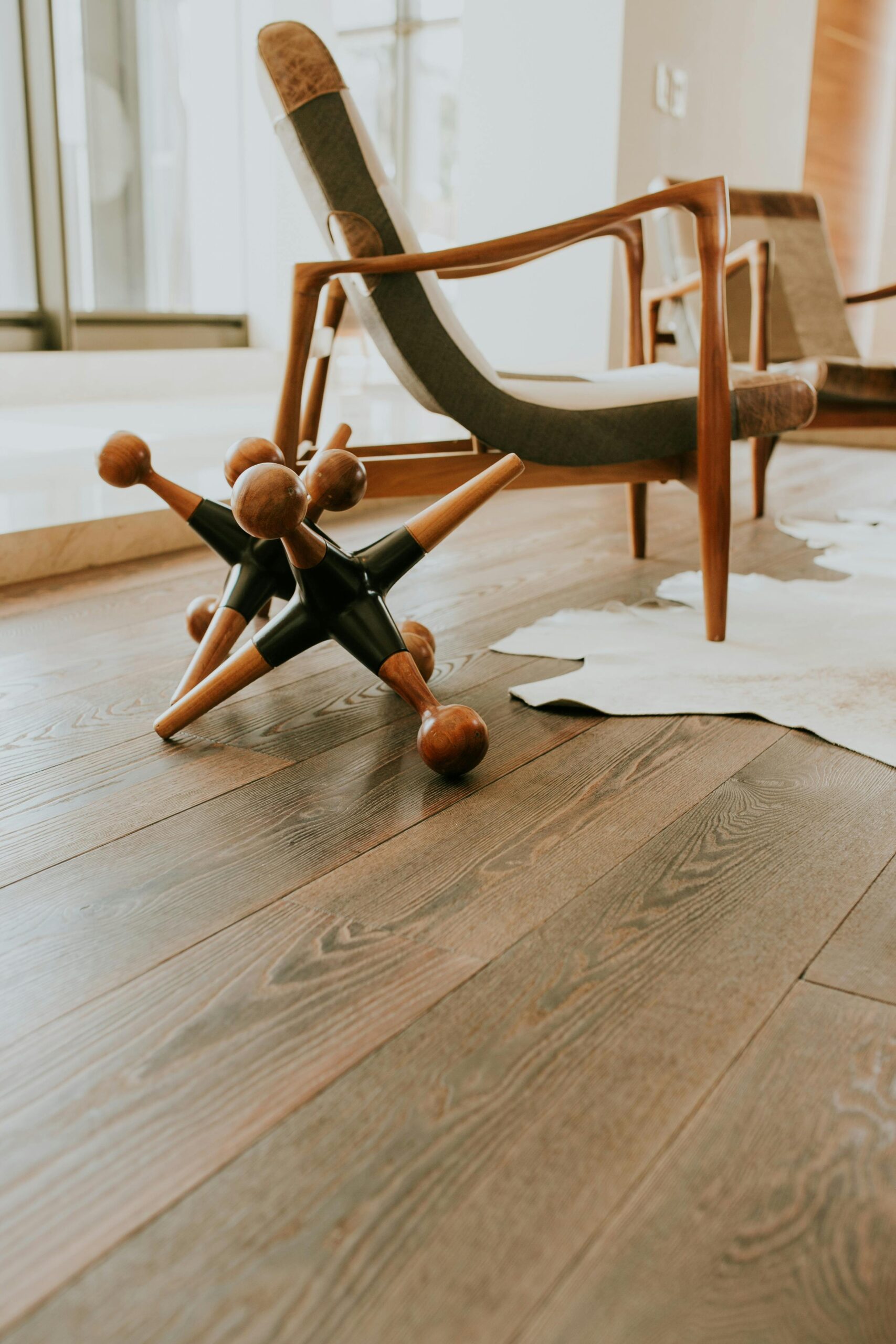 Stylish modern interior featuring a wooden armchair and unique decorative objects.