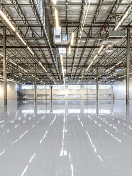 Spacious and polished industrial facility with glossy epoxy flooring in Houston, Texas.